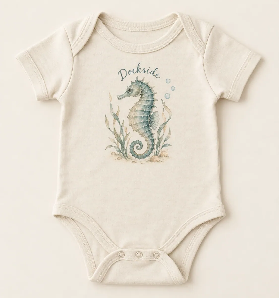 Natural Dockside Seahorse Infant Bodysuit with softly faded coastal illustration and Dockside lettering on the front