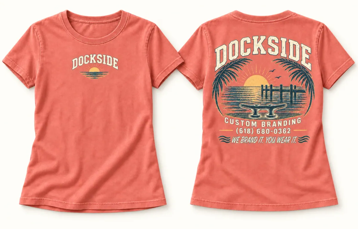 Washed coral women's Dockside tee showing a small tropical chest print and a large Florida sunset back print with the words We Brand It You Wear It.