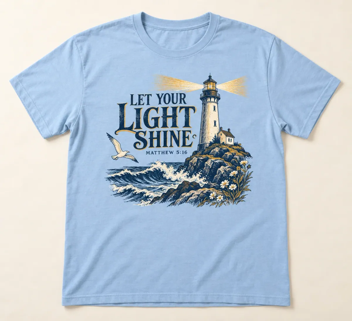 Light Blue t-shirts. A lighthouse casting golden beams across waves and rocky shoreline, with Let Your Light Shine and Matthew 5:16.