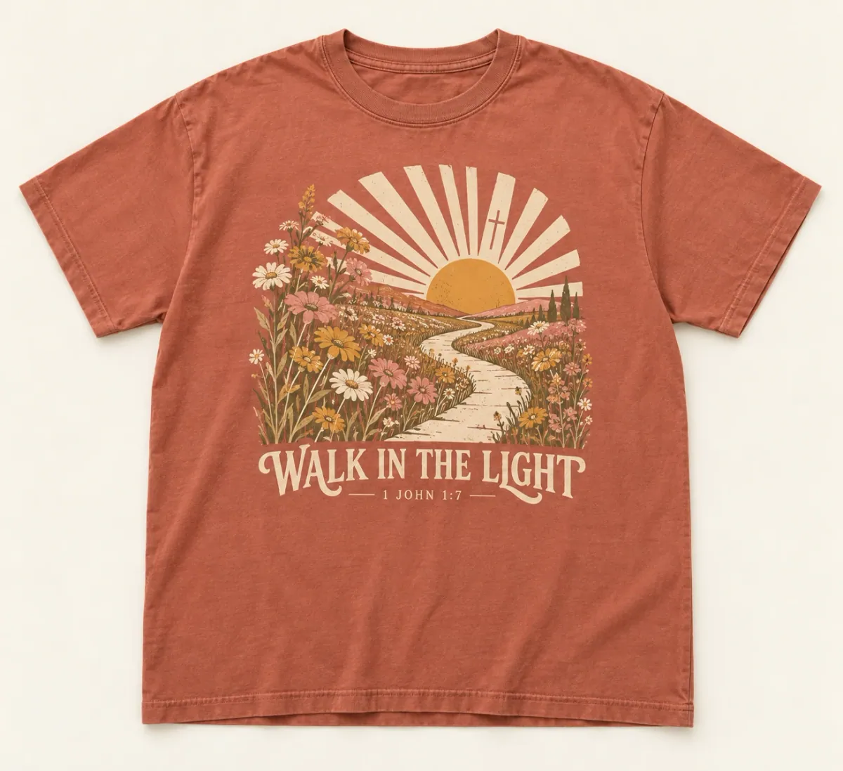 Terracotta t-shirts. A path through wildflowers toward a radiant sun and subtle cross, with Walk in the Light and 1 John 1:7.